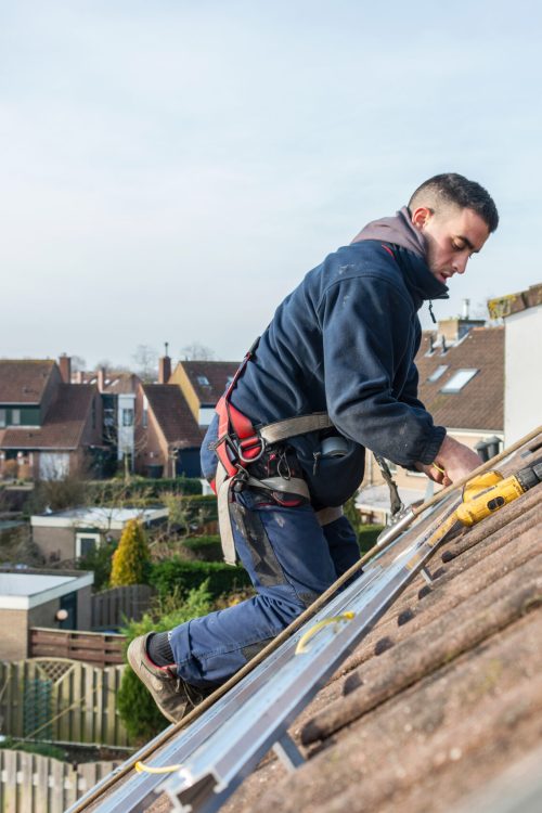 man making the construction for the solar panels Roof Repair Long Island
